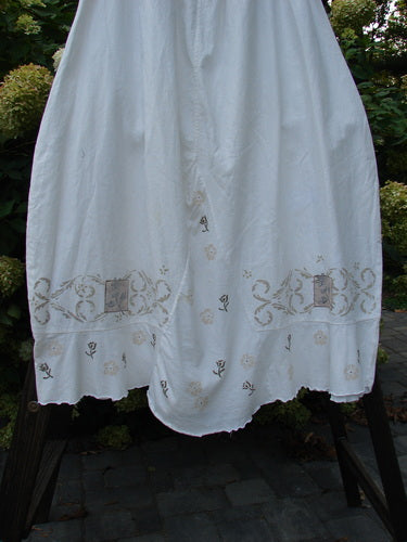 Barclay Linen Duet Skirt Tiny Floral White Size 2: A white dress with gold embroidery, widening bell shape, and tiny floral theme paint.