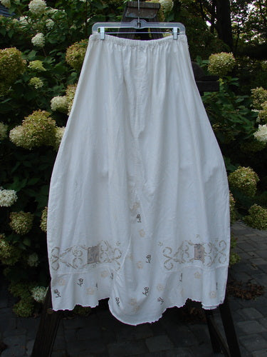 Barclay Linen Duet Skirt with tiny floral design, size 2. Full elastic waistline, widening bell shape, sectional panels, V-shaped insert, varying hemline, and lower flutter. Perfect condition. Length: 40".