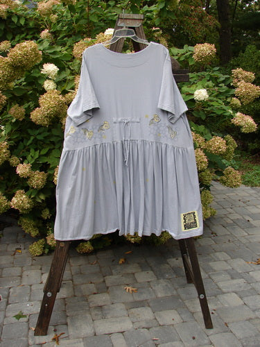 Image alt text: "1999 Carry All Dress Goldfish Bluebell Size 2: Grey dress on a rack with 8 ceramic and plastic buttons, tie accents, scoop neckline, and Blue Fish patch."