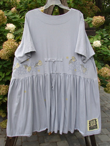 1999 Carry All Dress Goldfish Bluebell Size 2: A grey dress with a fish design on it. Features 8 blue fish buttons, front loops, and a draw cord. Scoop neckline and Blue Fish patch.