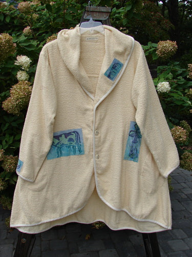 1996 Patched Cape Cod Coat with farm-themed patches, oversized pockets, and a single button closure. Made from cozy French Cotton Terry Cloth.