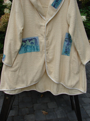1996 Patched Cape Cod Coat with farm-themed patches, oversized pockets, and a single button closure.