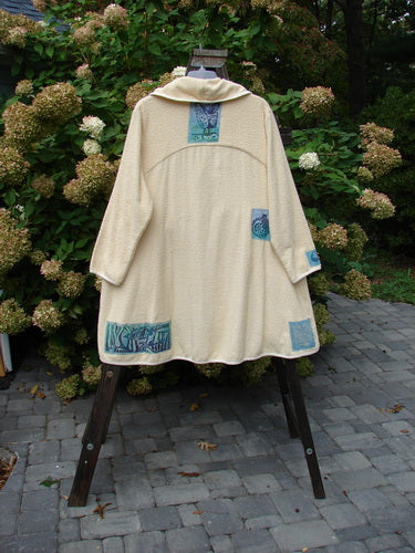 1996 Patched Cape Cod Coat on a stand, made from French Cotton Terry Cloth, with oversized pockets and a single button closure.