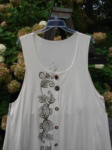1993 Long Column Vest Feather Fern Tea Dye OSFA: A white shirt with brown buttons, deeper arm openings, and a widening lower sweep. Features a deep oval-shaped neckline and a feather and fern theme painted on the front.