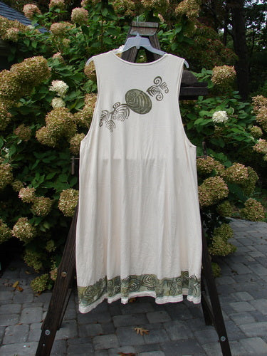 1993 Long Column Vest Feather Fern Tea Dye OSFA: A white dress on a swinger with green trim, featuring a design on a white shirt and a close-up of a turtle.