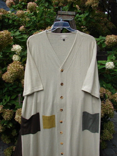 2000 Cotton Hemp 3 Block Cardigan Unpainted Dove Size 2: A long cardigan with pockets on a swinger, made from a hemp cotton blend. Straight shape, V neckline, tri-colored accents, and painted front pockets.