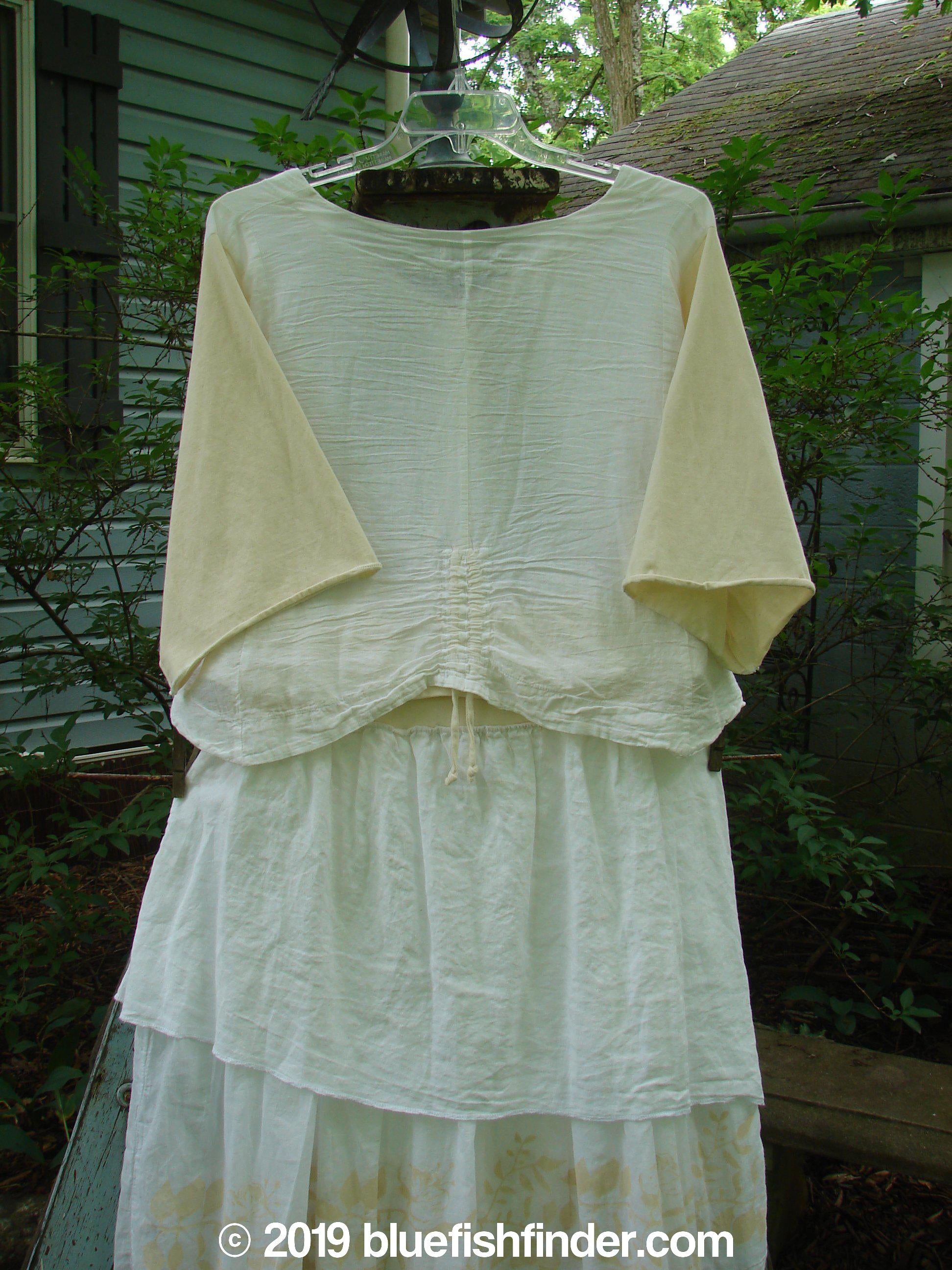 A white dress with long sleeves and a wider, boxier crop shape. Features include a three-button front, three-quarter length cotton sleeves, and vertical pull cord accents. The dress is part of the Barclay NWT Batiste Draw Midi Meadow Trio in White, Size 2.