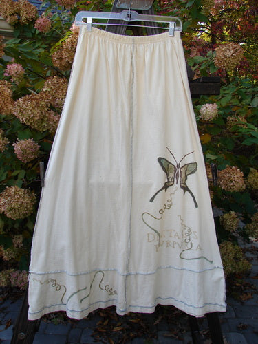 1998 Botanicals Sparrow Skirt Butterfly Queen Anne's Lace Smaller Size 2: A white skirt adorned with a butterfly design, featuring a full elastic waistline, exterior stitchery, and lower sectional panels. Made from mid-weight organic cotton.