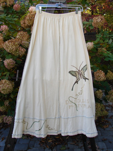 1998 Botanicals Sparrow Skirt Butterfly Queen Anne's Lace: A white skirt with a butterfly design, featuring full elastic waist, exterior stitchery, sectional panels, and a wide A-line flare. Made from mid-weight organic cotton. Size 2.