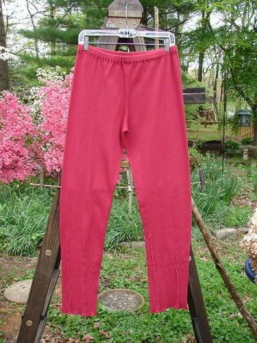 Barclay Cotton Lycra Layering Pinch Rib Pant Legging Unpainted Cranberry Size 2: A pair of pants on a clothes rack, featuring a soft forgiving textured rib feel and slightly fluttered lowers.