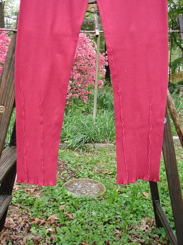 Barclay Cotton Lycra Layering Pinch Rib Pant Legging Unpainted Cranberry Size 2: A pair of pants on a clothes line, featuring a soft textured rib feel, fluttered lowers, and a forgiving fit. Perfect for creating your own distinctive look and feel.