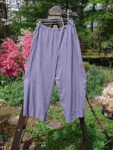 Barclay Linen Crop Drawstring Lounge Pant Unpainted Lavender Size 1: A pair of medium weight linen pants on a rack, featuring a full drawstring waistband, banded cuff, and crop length.