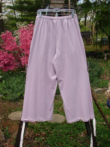 1999 Ribbon Pant Unpainted Orchid Size 1: A pair of pants with deep front bubble cargo pockets and button holes on each cuff, adorned with silk ribbon.