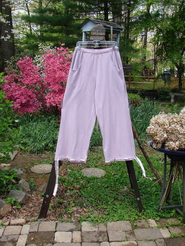 1999 Ribbon Pant Unpainted Orchid Size 1: A playful pant with elastic waistline, bubble cargo pockets, and buttoned cuffs with silk ribbon.