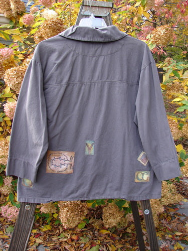 Image alt text: "2000 Patched Twill Elio Shirt Iron Size 2: A swingy A-line jacket with unique stitchery, oversized wooden buttons, and painted patches on organic brushed cotton twill."