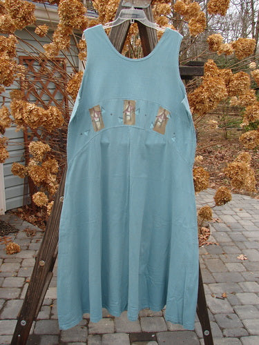 1995 Zelda Jumper Dress Triple Pagoda Venus Size 2: A blue dress with a picture of a house on it, on a wooden rack.