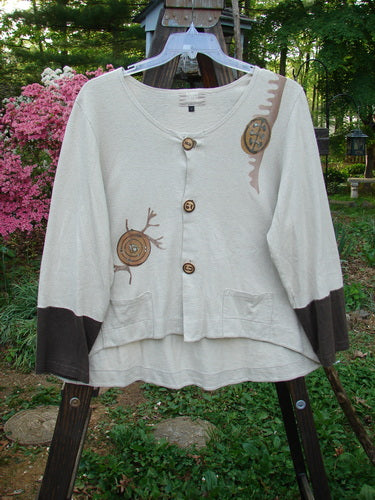 2000 Cotton Hemp Philois Jacket Bio Dove Bark Size 1: A white sweater with brown and black designs on a rack.