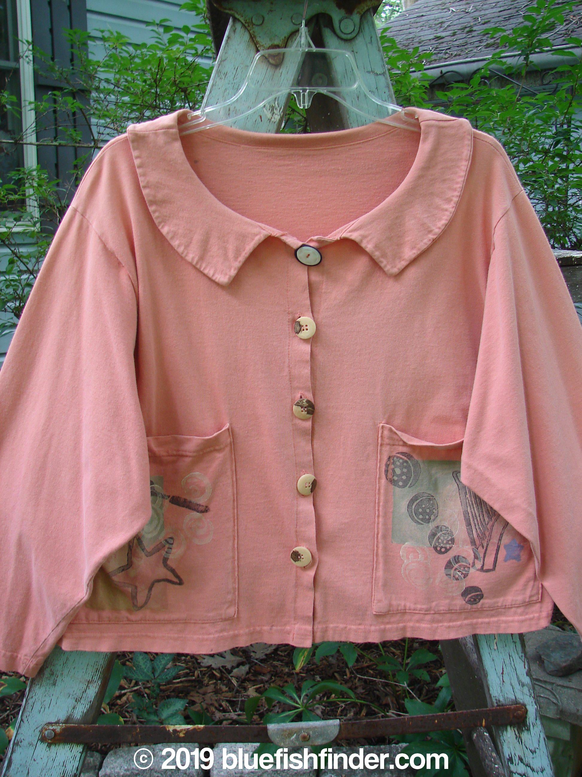 Image alt text: 1994 Box Pocket Jacket Reef Harp Star Size 1 - A pink shirt with buttons on a clothesline, featuring a unique collar, oversized front pockets, and a cropped boxy shape.
