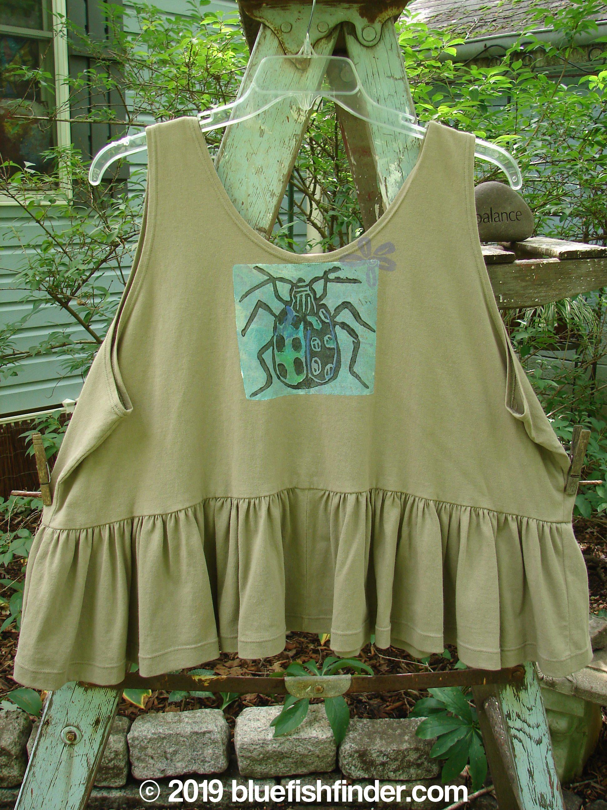 1992 Peplum Top Beetle Wheat OSFA: A rare vintage flounce top with a beetle theme. Mid-weight cotton, yoked waist seam, rounded neckline, wide waist, and gathered bottom flounce. Bust 50, waist 54, hem circumference 100, length 25 inches.