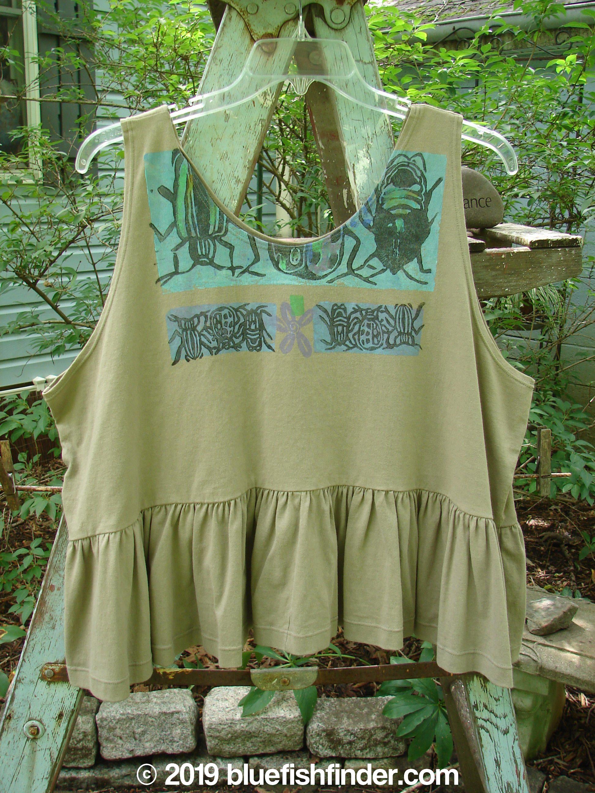 1992 Peplum Top Beetle Wheat OSFA: A rare vintage flounce top with a bug design. Mid-weight cotton, yoked waist seam, rounded neckline, wide waist, and gathered bottom flounce. Bust 50, waist 54, hem circumference 100, length 25 inches.