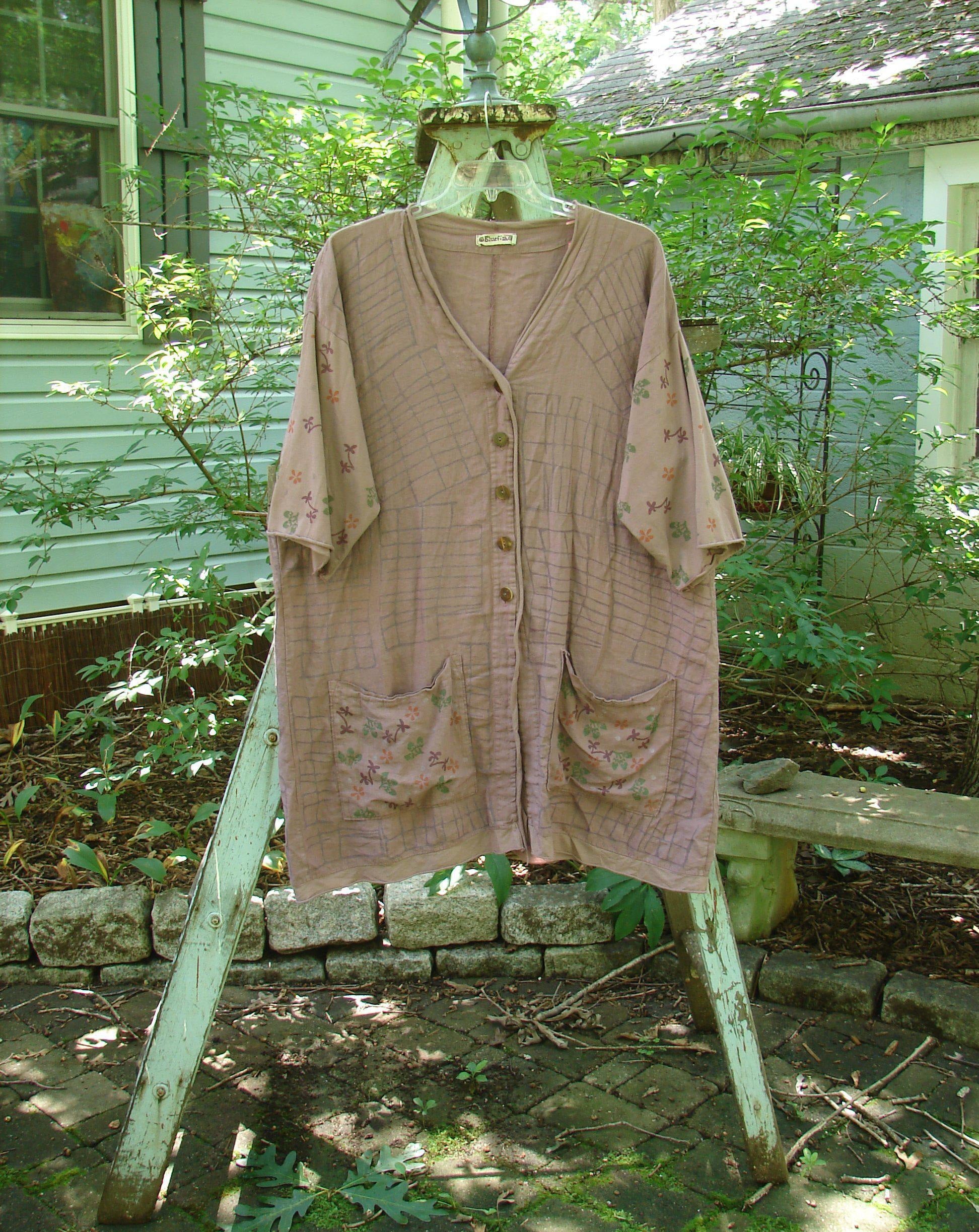 Barclay Linen Cotton Sleeve Pocket Cardigan Rich Mauve Size 0: A shirt with a floral design on a clothes rack.