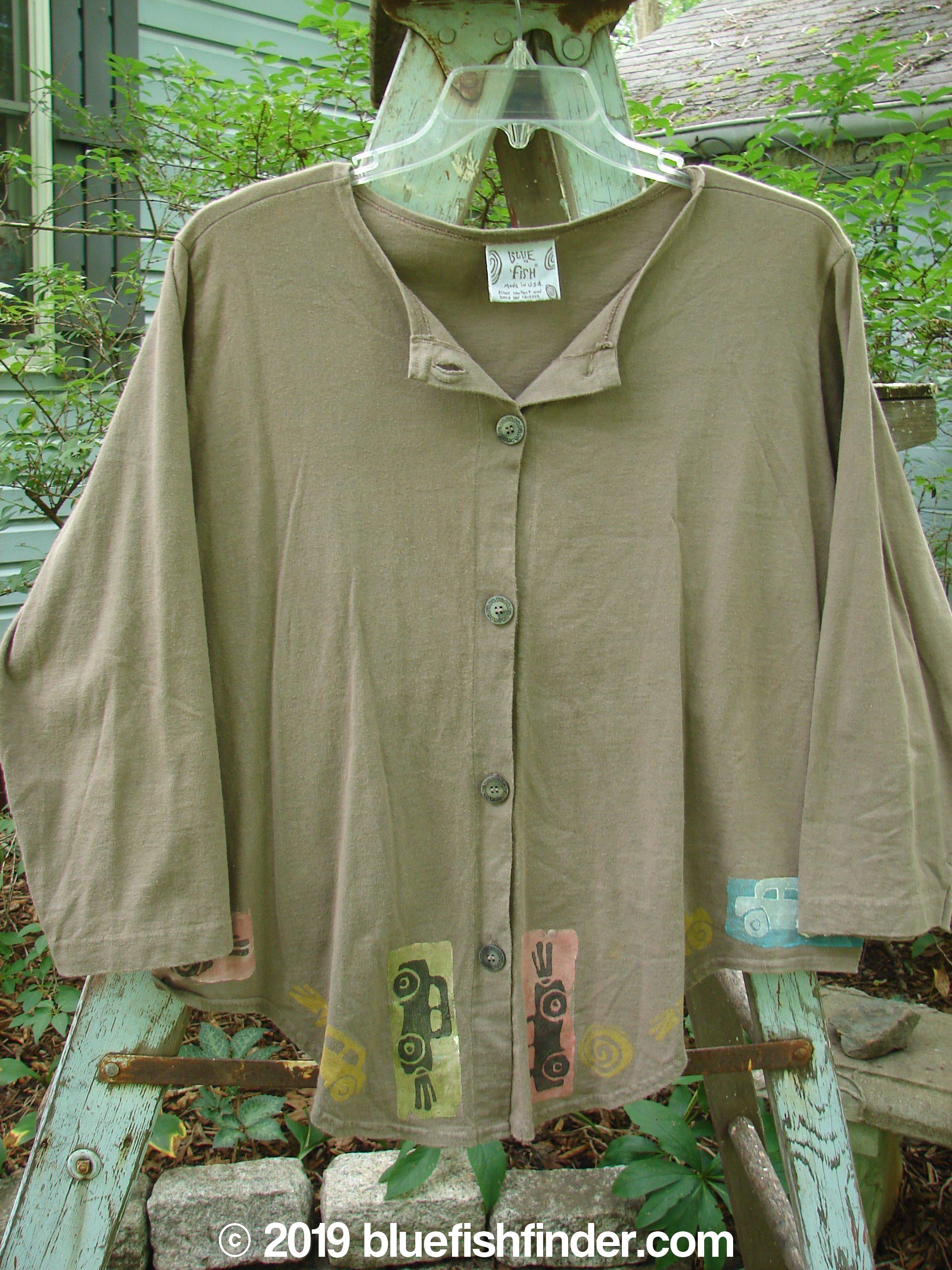 Image alt text: "1993 Tie Back Jacket Car Bay Leaf OSFA: A brown shirt with a patch on it, featuring a top vintage button, drop shoulders, and varying front and back hemline. Made from mid-weight cotton, this vintage collectible is in perfect condition."
