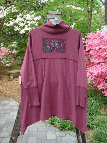 Barclay Hemp Cotton Turtleneck Pocket Dress Silly Pup Loam Size 2: A purple jacket with a picture of a dog on it, featuring a thermal turtleneck, sectional panels, and drop pockets.