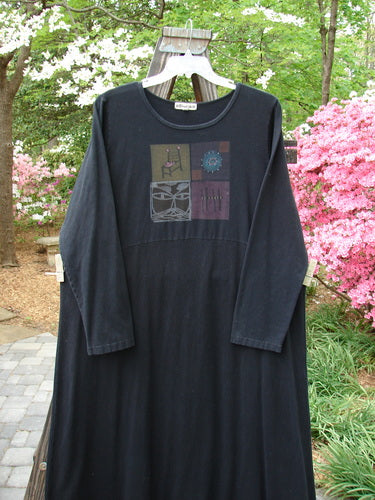A black dress with a graphic design featuring the Kitty Kitty and High Back Chair theme along the hem. Made from medium weight hemp cotton, this Barclay Hemp Cotton Curved A Line Dress is in perfect condition with two professionally mended pinholes at the hem of the skirt. It has an extra long length, a wide A-line shape, a downward curved empire waist seam, and longer cozy sleeves. Bust: 52, Waist: 56, Hips: 58, Sweep: 90, Length: 57 inches. Size 2.
