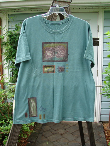 Image alt text: 1993 Short Sleeved Tee with tractor pattern on a swinger, grey green, OSFA.