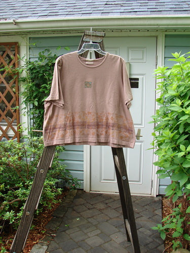 2000 Short Sleeved Crop Tee with Floral Fence Border in Coralline. A shirt on a ladder, close-up of a plant, wooden post, and metal pole.