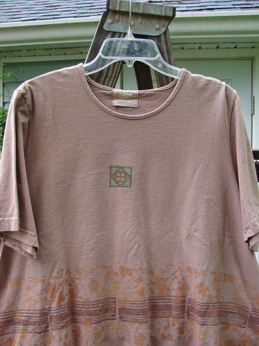 2000 Short Sleeved Crop Tee with Floral Fence Border in Coralline. Mid Weight Organic Cotton. Sweet stained glass window paint. Shallow neckline. Widening crop box shape. Signature Blue Fish Patch. Measurements: Bust 52, Waist 52, Hips 54, Length 23.