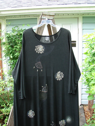 1995 Acetate Lycra Celebration Dress with Celtic Turn design. Black shirt on a swinger with a plant close-up.