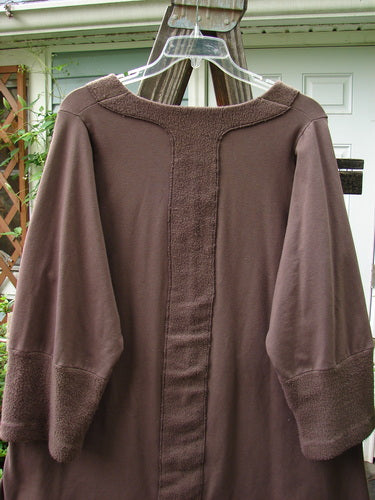 Image: A brown shirt on a clothes hanger.

Alt text: Barclay Cotton Lycra Celtic Moss Single Pocket Tunic Top in Mocha, Size 1, on a clothes hanger.