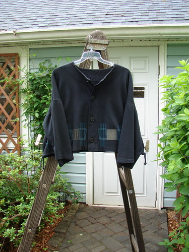 1999 Interlock Side Tie Jacket Fall Grid Black Size 2: A black jacket with wide belled sleeves and a unique rubber-like button front.