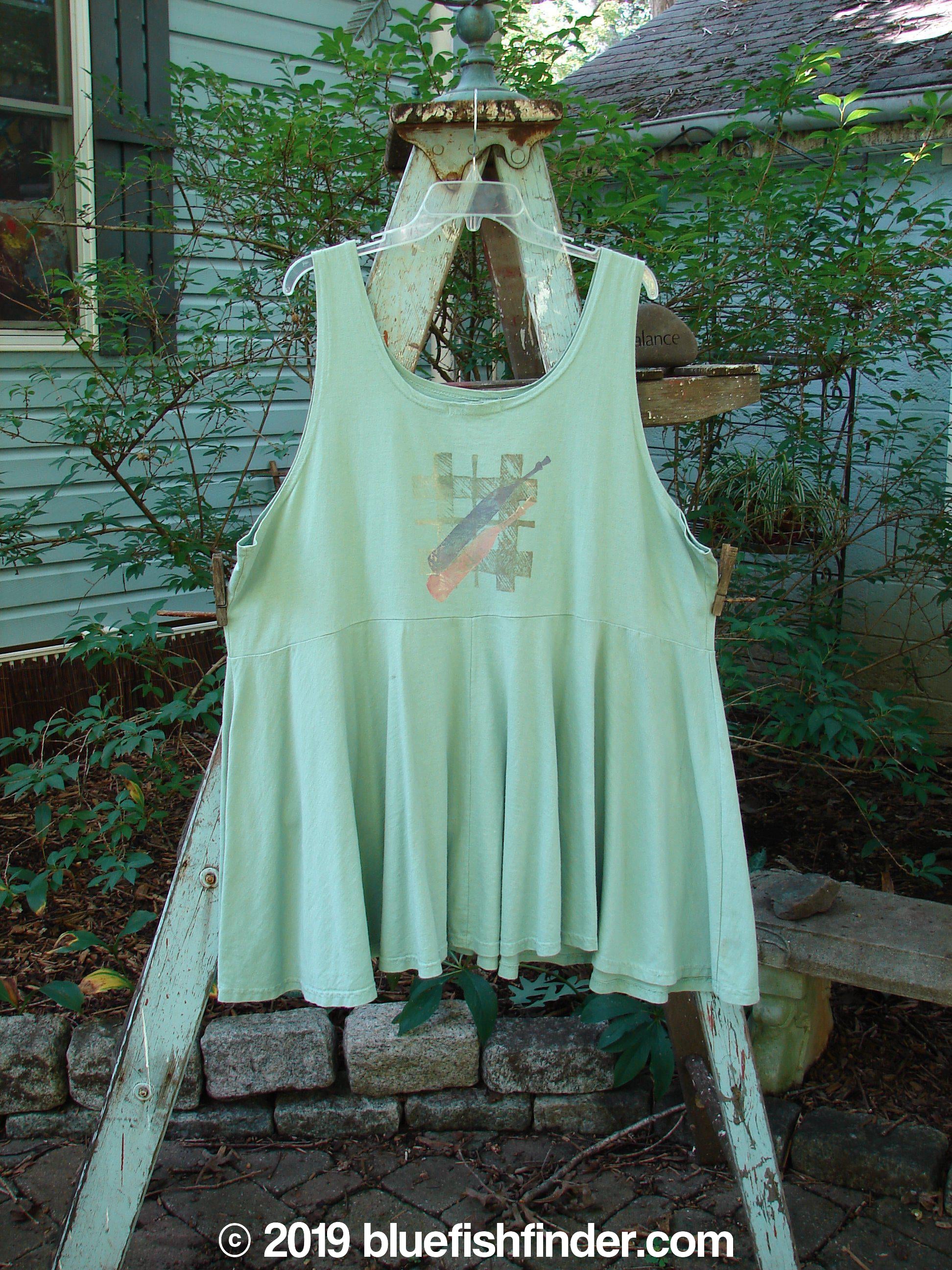 1995 Patio Rose Dress Jumper Bottles Dinette Green OSFA: A green dress with a flouncy lower, empire waistline, and scooped neckline. Features a colorful tall stem bottle theme paint.