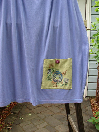 1997 Big Pocket Skirt Bolder Skylark Size 1: A blue cloth skirt with a unique bell-shaped bottom and a super giant lower exterior pocket. Features a drawstring waistline and two deep side pockets.
