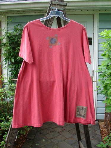1997 Montage Dress Space Odyssey Geranium Size 1: A swingy A-line dress made from medium weight organic cotton. Features oversized front pockets with vintage buttons, classic Odyssey theme paint, and a rounded neckline. Bust 48, Waist 54, Hips 60, Length 35 inches.