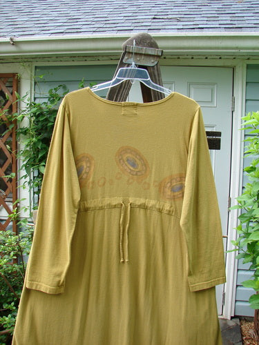 1999 Curved A Line Dress Rolling Gold Size 1: A yellow dress with a downward yoked waistline, deep side pockets, and a big bottom flair. Made from organic cotton.