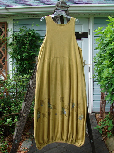 A yellow dress on a clothes rack, part of the 2000 Cotton Hemp Libby Jumper Fall Leaf Gold Size 1 collection.