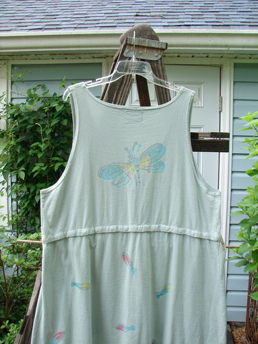 Barclay Little Tree Vest Dragonfly Fish Cucumber Size 1: A white shirt with a butterfly drawn on it, featuring a dragonfly drawing and a close-up of a plant.