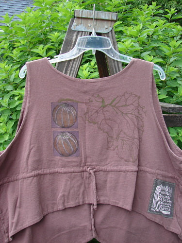 1998 Field Vest Leaf Gourd Size 1: A brown shirt with a graphic design of fruit on it, featuring a specialized upward curved crop rear and tuxedo front tails. Made from 100% organic cotton.