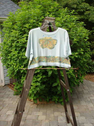 1992 Short Sleeved Crop Tee with butterfly and daisy theme on blue tourmaline fabric.