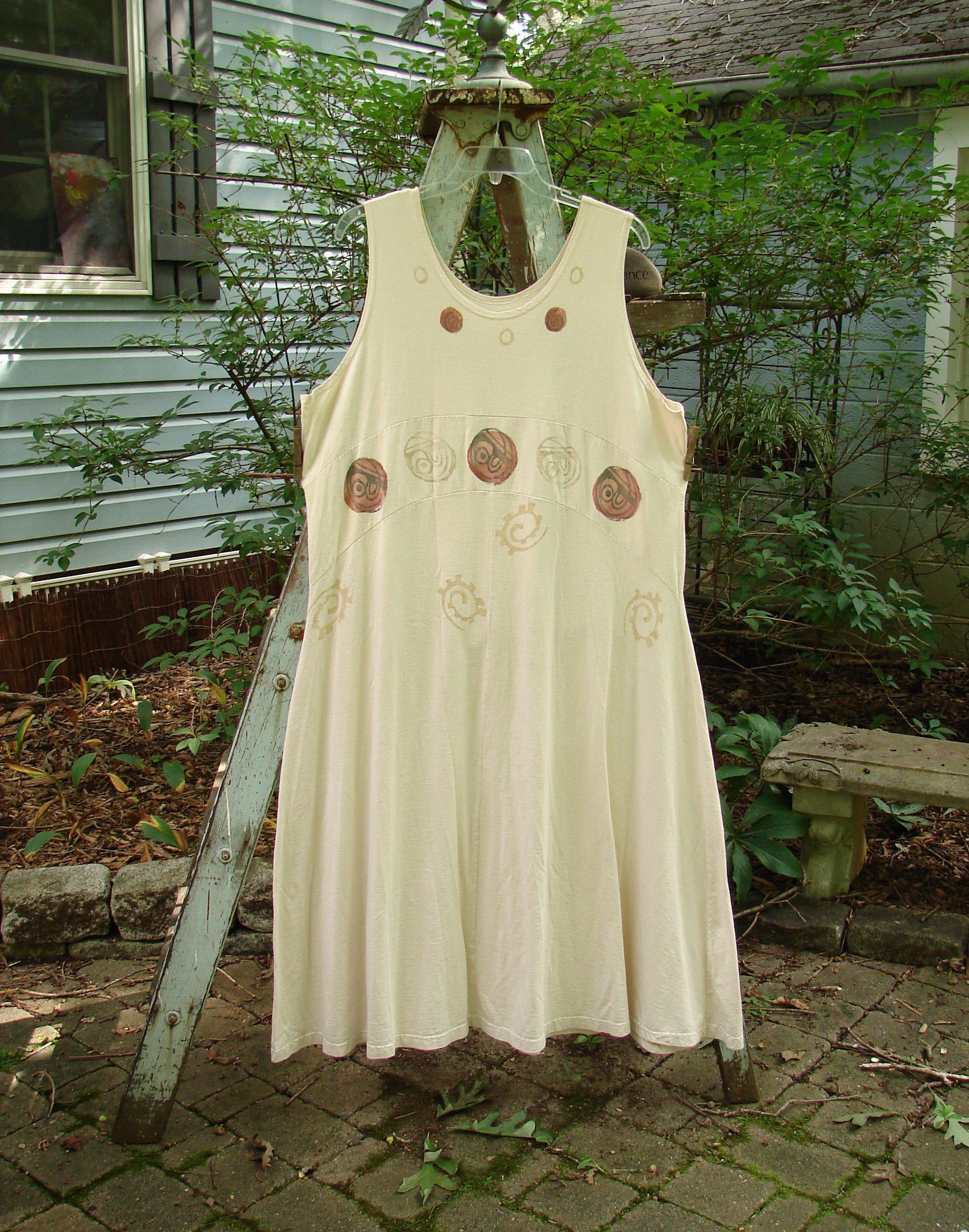 A white dress with abstract paint design on a clothes rack. Zelda Jumper Dress from the 1995 Resort Collection in Champagne, Size 2.