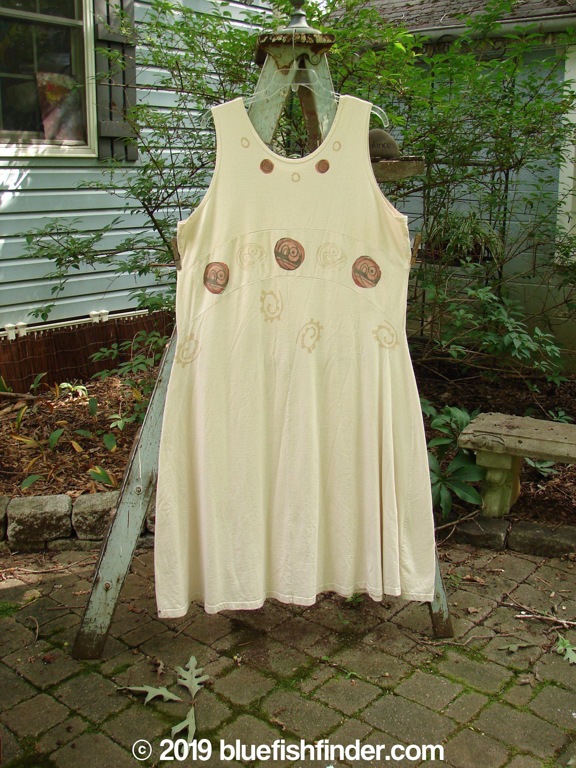 A white dress with brown abstract designs on a clothes rack. 1995 Zelda Jumper Dress Abstract Champagne Size 2.