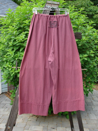 Image alt text: 1992 Belle Pant on clothes rack, pink pants with widening leg and banded cuff. Medium weight cotton jersey. OSFA.