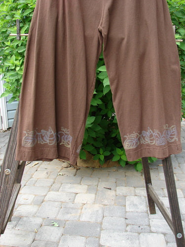 Image alt text: "1992 Buttonloop Pant Grape Leaf Bay Leaf OSFA: Brown pants with button-loop details and deep side pockets."