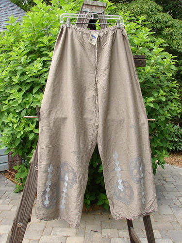 2000 NWT Shaunting Silk Drawcord Pant Travel Cement Size 2: A pair of pants on a clothesline, featuring a design, wider hips, and a longer inseam.