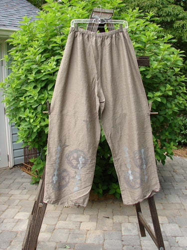 2000 NWT Shaunting Silk Drawcord Pant Travel Cement Size 2: A pair of pants on a clothes rack, wider hips and lowers, rear elastic waistband with drawcord front.