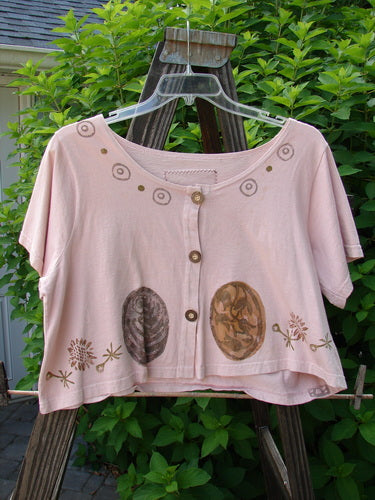 1993 Travel Top Oval Gardens Dried Rose Size 1: Pink shirt on a swinger with brown designs. Close-up of a painting.