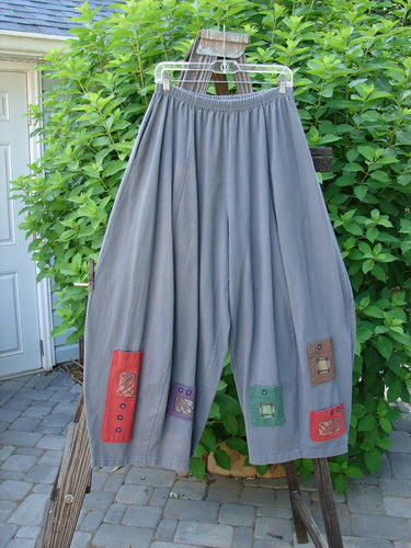 1997 Nuts and Bolts Pant Window Granite Size 1: A pair of pants with patchwork pockets, perfect for keeping your little nuts, bolts, and trinkets!